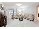 Living room with beige sofas, coffee table, and tile floors at 3033 Sangria St, Kissimmee, FL 34744