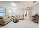 Living room with beige sofas, coffee table, and tile floors at 3033 Sangria St, Kissimmee, FL 34744