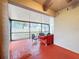 Screened porch with red brick flooring and comfortable seating at 3033 Sangria St, Kissimmee, FL 34744