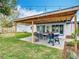 View of paver patio featuring a covered pergola, dining set, grill and a shed for added storage space at 420 Sunrise Dr, Orlando, FL 32803