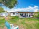 Spacious backyard features a covered patio, dining area, mature tree, and a storage shed at 420 Sunrise Dr, Orlando, FL 32803