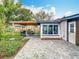 Paver patio in backyard with outdoor dining area and grill under a wooden pergola, perfect for entertaining at 420 Sunrise Dr, Orlando, FL 32803