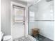 Modern bathroom with glass-enclosed shower, decorative floor tiles, and sleek white fixtures at 420 Sunrise Dr, Orlando, FL 32803
