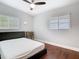 Well-lit bedroom with hardwood flooring, two windows, ceiling fan, and a simple, modern design at 420 Sunrise Dr, Orlando, FL 32803