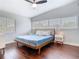 Bright bedroom with hardwood floors, two large windows, and a minimalist aesthetic at 420 Sunrise Dr, Orlando, FL 32803