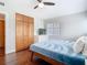 Bright bedroom features a ceiling fan, hardwood floors, and a large built-in closet at 420 Sunrise Dr, Orlando, FL 32803