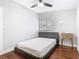 Comfortable bedroom with hardwood floors, ceiling fan, window, and minimalist decor at 420 Sunrise Dr, Orlando, FL 32803