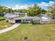 Charming single-story home with a well-maintained lawn and an orange front door at 420 Sunrise Dr, Orlando, FL 32803