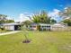 Charming single-story home boasts a well-manicured lawn and an inviting orange front door at 420 Sunrise Dr, Orlando, FL 32803