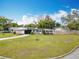 Charming single-story home boasts a well-manicured lawn and an inviting orange front door at 420 Sunrise Dr, Orlando, FL 32803