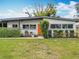 Charming home exterior boasts an orange front door, modern accents, and well-maintained landscaping at 420 Sunrise Dr, Orlando, FL 32803