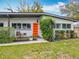 Charming front exterior features a bright orange door, modern landscaping, and cozy seating area at 420 Sunrise Dr, Orlando, FL 32803