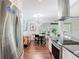 Gourmet kitchen flows to dining area featuring stainless appliances and granite countertops at 420 Sunrise Dr, Orlando, FL 32803