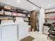 Spacious laundry room with washer, dryer, storage shelves and tile flooring at 420 Sunrise Dr, Orlando, FL 32803