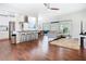Stylish living room featuring an open floor plan, hardwood floors, and stainless steel appliances at 420 Sunrise Dr, Orlando, FL 32803