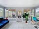 Bright sun room with patterned tile flooring and sliding glass door to back yard at 420 Sunrise Dr, Orlando, FL 32803