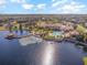 Aerial view of a lakefront clubhouse featuring a pool, patio, and other recreational facilities at 605 Cantabria Dr, Davenport, FL 33837