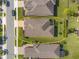 Aerial view of a well-maintained home with a large, green lawn and neatly landscaped yard at 605 Cantabria Dr, Davenport, FL 33837