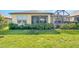 Spacious backyard featuring a well-maintained lawn, patio and mature shrubbery for privacy and relaxation at 605 Cantabria Dr, Davenport, FL 33837