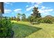 Lush backyard featuring a well-maintained lawn and green shrubbery with plenty of room for recreation and relaxation at 605 Cantabria Dr, Davenport, FL 33837
