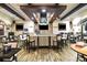 Community bar with TV's, bar stools and tables for members to enjoy at 605 Cantabria Dr, Davenport, FL 33837