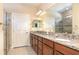 This bathroom has double sinks with granite countertops and glass enclosed shower at 605 Cantabria Dr, Davenport, FL 33837