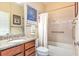 Bright bathroom with granite countertops and a shower-tub combo with decorative accent tiles at 605 Cantabria Dr, Davenport, FL 33837