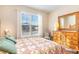 This bedroom has a large window and a bamboo framed mirror at 605 Cantabria Dr, Davenport, FL 33837