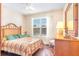 This bedroom has wood floors, lots of natural light, and a decorative mirror at 605 Cantabria Dr, Davenport, FL 33837
