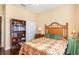 Cozy bedroom featuring a decorative bamboo headboard and bookshelf filled with assorted books at 605 Cantabria Dr, Davenport, FL 33837