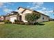 Inviting single-story home featuring lush landscaping, a well-maintained lawn, and an attached two-car garage at 605 Cantabria Dr, Davenport, FL 33837