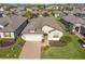 Beautiful single-story home featuring a well-manicured lawn, lush landscaping, and a brick paver driveway at 605 Cantabria Dr, Davenport, FL 33837
