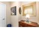 Hallway featuring elegant mirror, lamp, and dresser at 605 Cantabria Dr, Davenport, FL 33837
