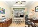 Charming home office with modern ceiling fan and tray ceiling, showcasing natural light and creative workspace at 605 Cantabria Dr, Davenport, FL 33837
