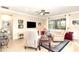 Cozy living room with neutral tones and a large window offering natural light at 605 Cantabria Dr, Davenport, FL 33837
