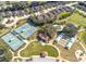 Aerial view of the community tennis courts and meticulously maintained landscaping at 605 Cantabria Dr, Davenport, FL 33837