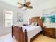 Bedroom with tropical decor and private balcony at 754 Golf Course Pkwy, Davenport, FL 33837