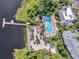 Aerial view of resort-style pool, beach area, dock, and lush landscaping at 801 New Providence # B19/U801, Davenport, FL 33897