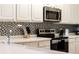 Modern kitchen with stainless steel appliances at 801 New Providence # B19/U801, Davenport, FL 33897