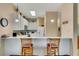 Kitchen with white cabinets, breakfast bar, and view into living area at 801 New Providence # B19/U801, Davenport, FL 33897