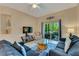 Spacious living room featuring comfortable seating, a large TV, and access to a patio at 801 New Providence # B19/U801, Davenport, FL 33897