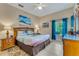 King-size bed, large dresser, and ocean-themed decor in a relaxing main bedroom at 801 New Providence # B19/U801, Davenport, FL 33897