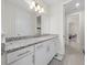 Bathroom with granite countertop, white cabinets, and a spacious layout at 8024 Leaf Grove Cir, Orlando, FL 32836