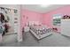 bedroom with Hello Kitty bedding and a walk-in closet at 8024 Leaf Grove Cir, Orlando, FL 32836
