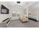 Main bedroom with sitting area, large TV and cozy sofa at 8024 Leaf Grove Cir, Orlando, FL 32836