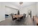 Elegant dining room with wood table and modern light fixture at 8024 Leaf Grove Cir, Orlando, FL 32836