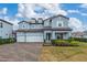 Two-story house with three-car garage and landscaped front yard at 8024 Leaf Grove Cir, Orlando, FL 32836