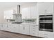 Modern kitchen with white cabinets, stainless steel appliances, and quartz countertops at 8024 Leaf Grove Cir, Orlando, FL 32836