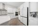 Bright kitchen featuring white cabinets, stainless steel appliances, and a large island at 8024 Leaf Grove Cir, Orlando, FL 32836