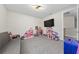 Playroom with gray couch, a large TV, and plenty of toy storage at 8024 Leaf Grove Cir, Orlando, FL 32836